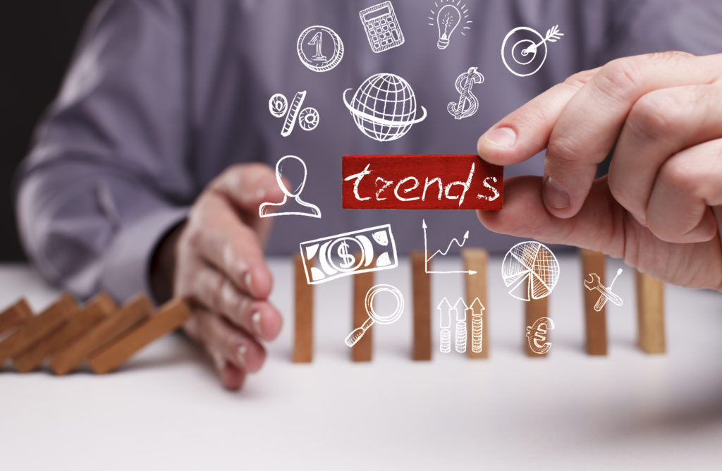 Business, Technology, Internet and network concept. Young businessman shows the word: trends
